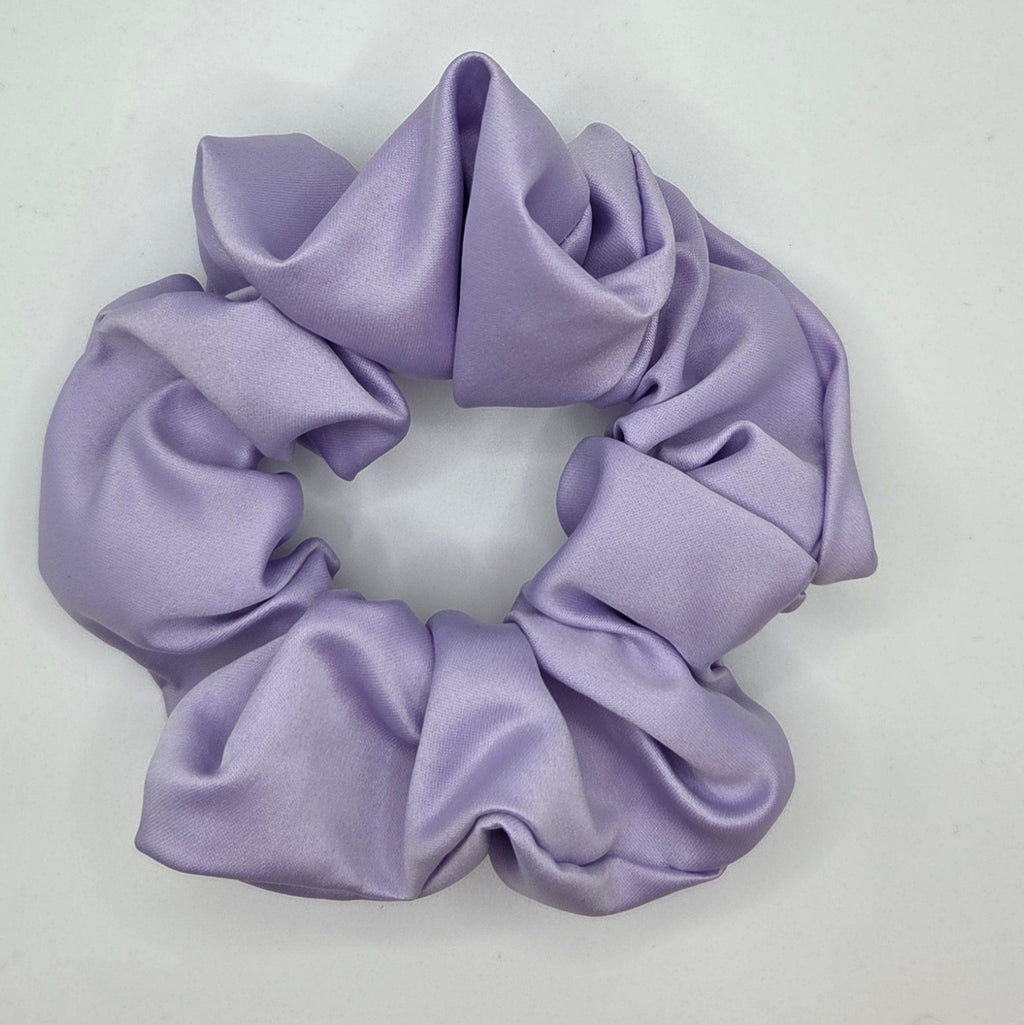 A lavender purple satin scrunchie on a plain white background.