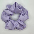 A lavender purple satin scrunchie on a plain white background.